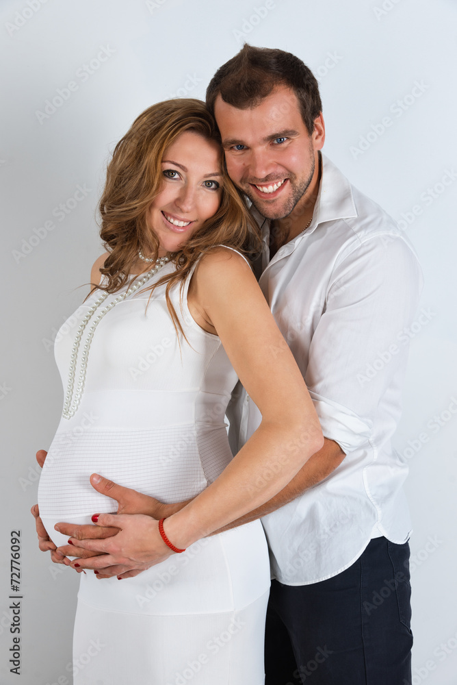 Fototapeta premium Happy Pregnant Couple on white background