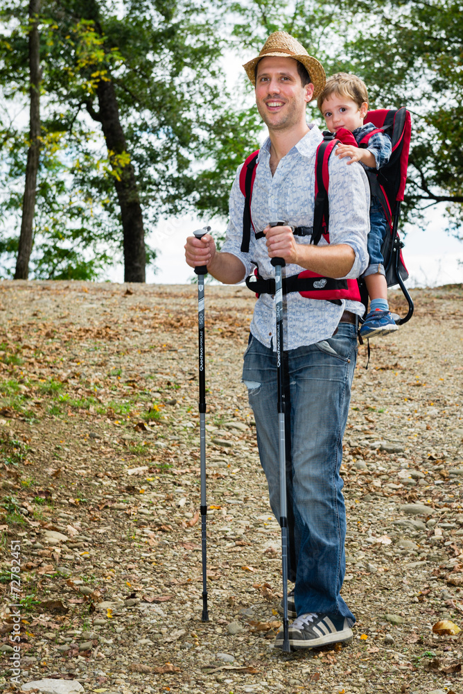 Baby with father travelling with son in the backpack Baby with father travelling with son in the backpack