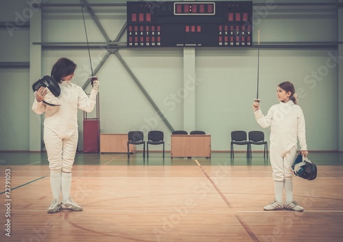 Little girl fencer and her trainer