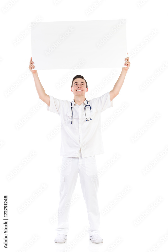 Happy male doctor holding empty placard over his head Happy male doctor holding empty placard over his head