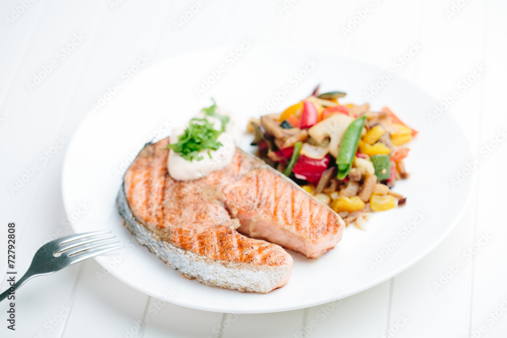 Grilled Salmon with Fresh vegetables on white background Grilled Salmon with Fresh vegetables on white background
