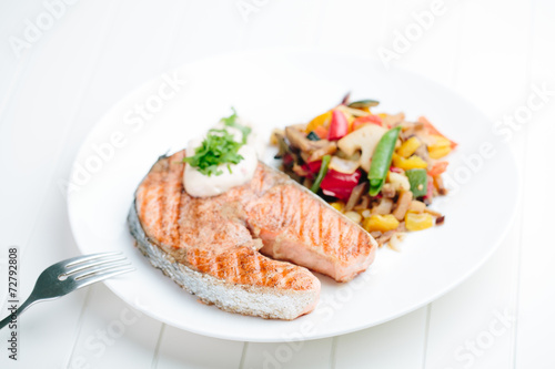 Grilled Salmon with Fresh vegetables on white background