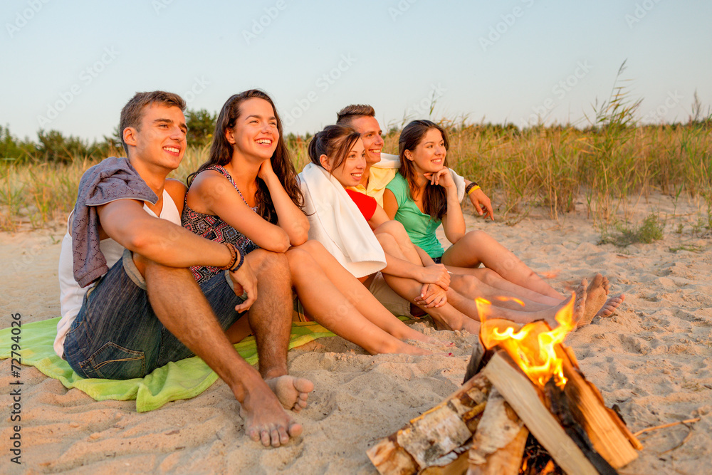 smiling friends in sunglasses on summer beach smiling friends in sunglasses on summer beach