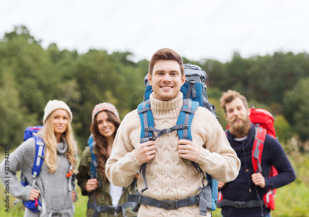 group of smiling friends with backpacks hiking group of smiling friends with backpacks hiking
