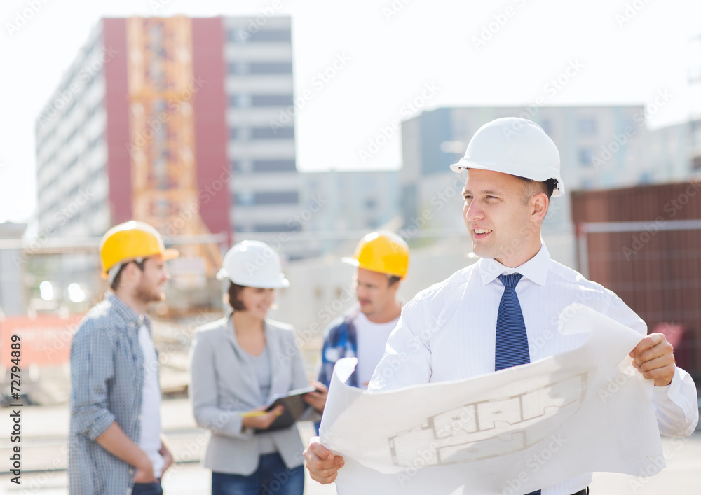 group of builders with tablet pc and blueprint group of builders with tablet pc and blueprint