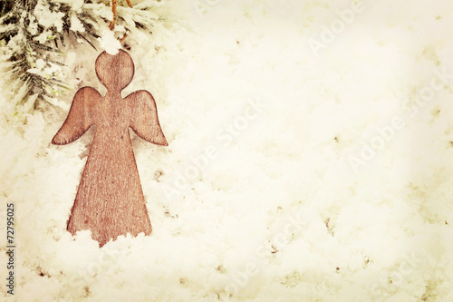 Vintage Christmas angel on snow background