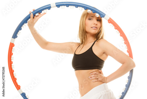 sporty fit girl doing exercise with hula hoop. © Voyagerix
