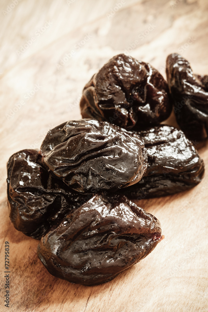 dried plums prunes on wooden table dried plums prunes on wooden table