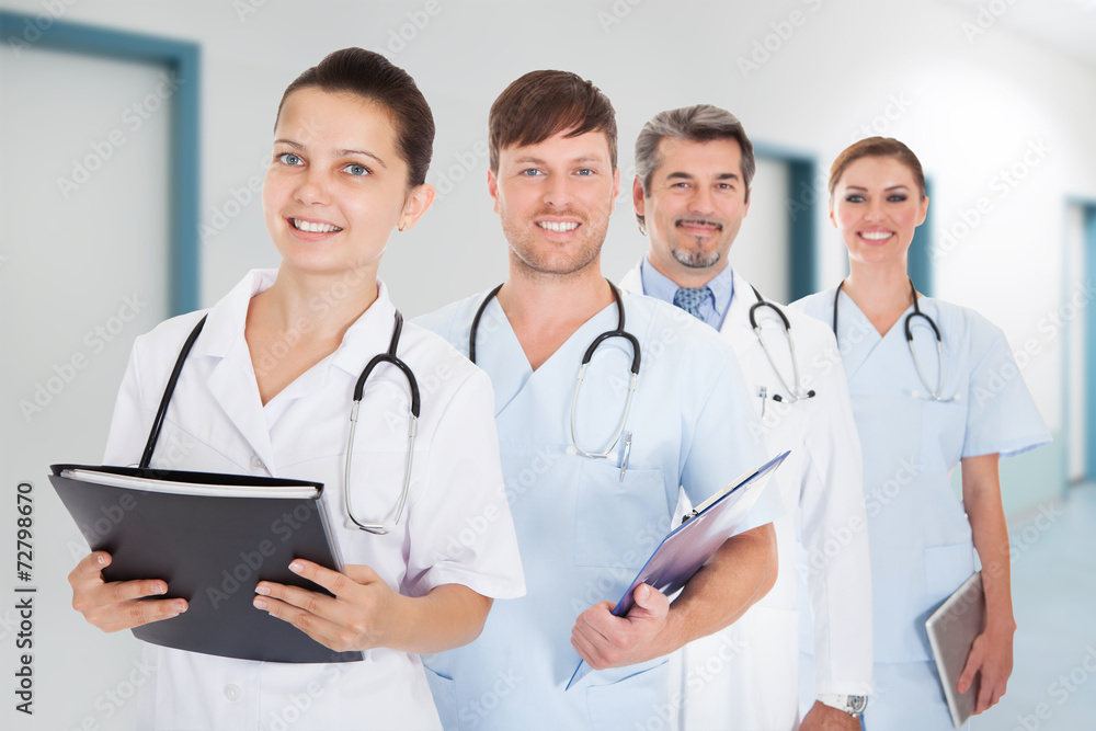 Doctors With Documents And Digital Tablet Standing In Row Doctors With Documents And Digital Tablet Standing In Row