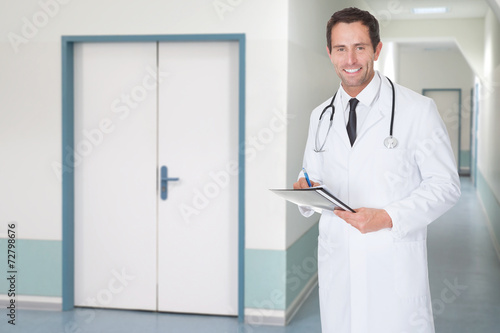 Confident Doctor Holding File In Hospital Corridor