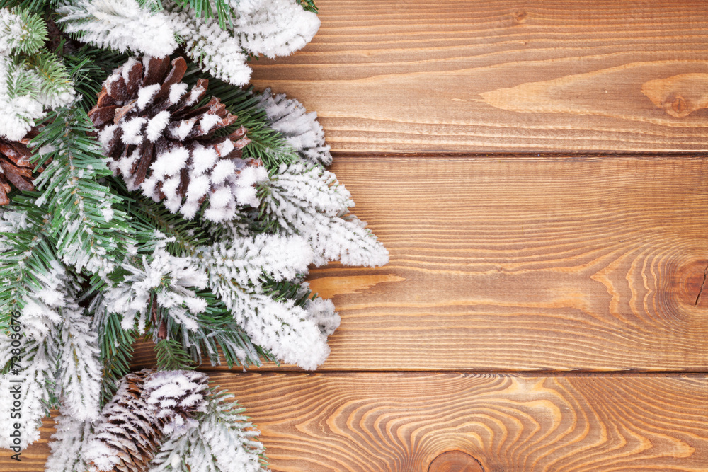 Christmas fir tree with snow on rustic wooden board Christmas fir tree with snow on rustic wooden board