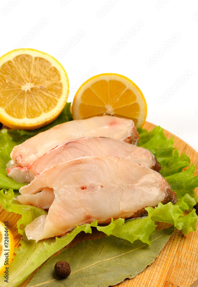 Several pieces of sea bass on a cutting board. Several pieces of sea bass on a cutting board.