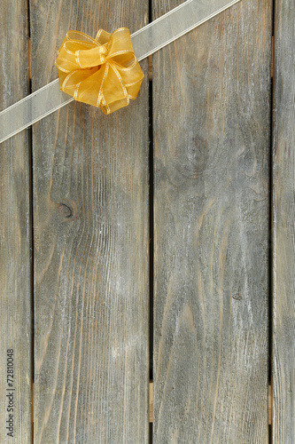 Old wooden background with beautiful bow