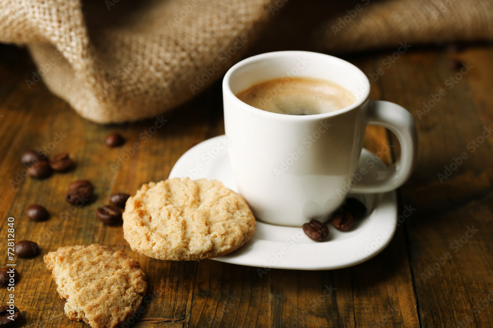Cup of espresso and tasty cookie on wooden background Cup of espresso and tasty cookie on wooden background