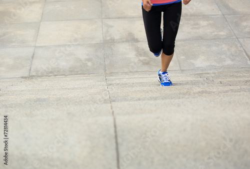 young fitness woman legs running up on stairs 