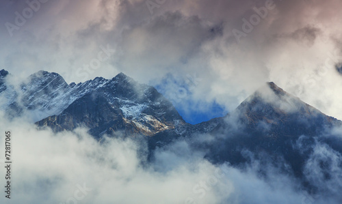 Snow covered mountains and rocky peaks in Himalaya © Calin Tatu