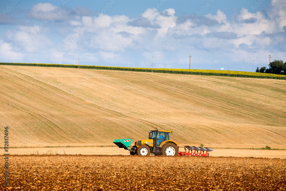 Obraz premium tractor harrowing a field