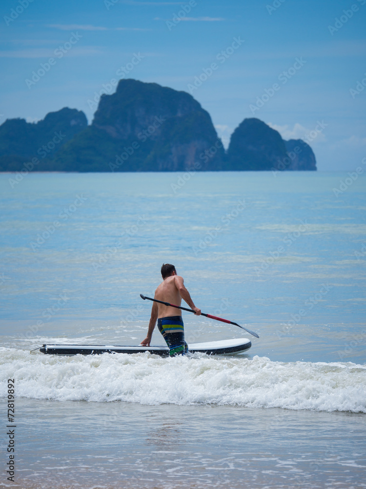 Man Stand up paddle surfing in Thailand Man Stand up paddle surfing in Thailand