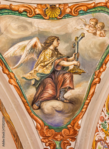 Seville - baroque fresco of angel with the symbolic cross photo