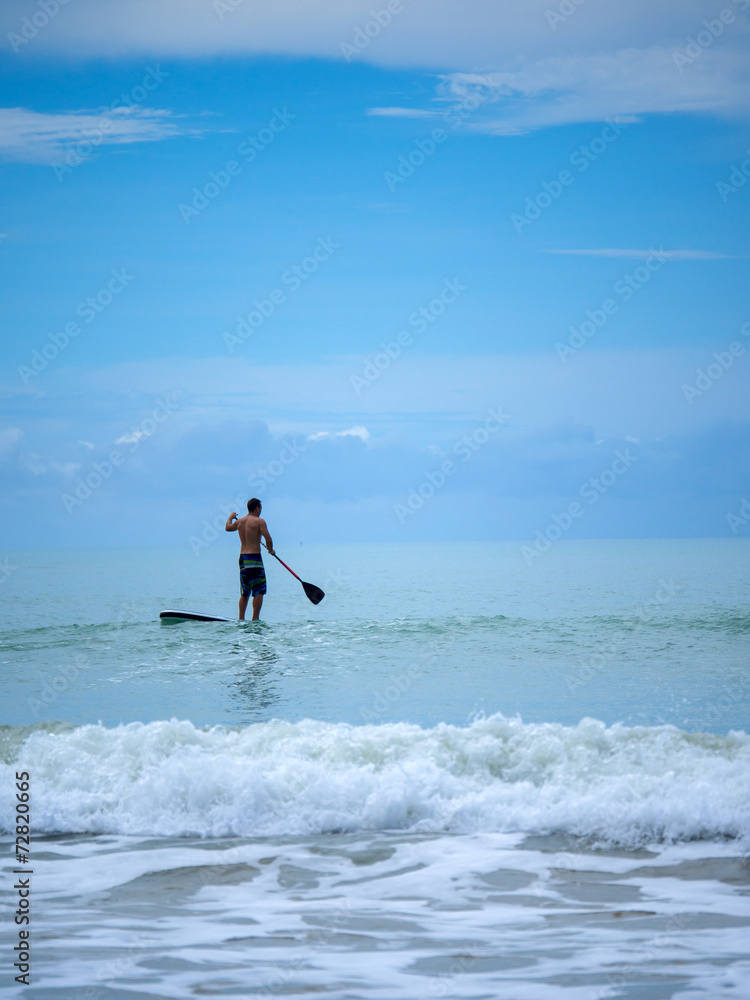 Man Stand up paddle surfing in Thailand Man Stand up paddle surfing in Thailand