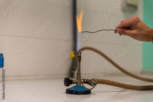Photos powder test a Bunsen burner showing flame and hose.