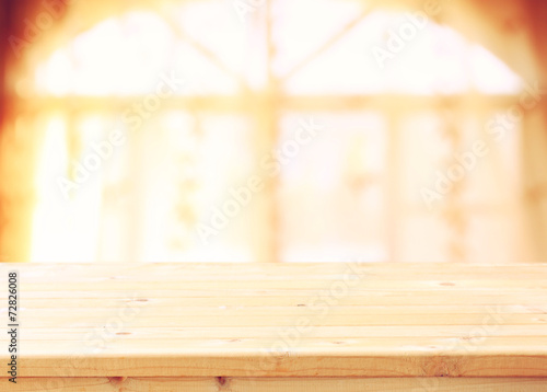 empty wooden table and window light background. filtered image.  © tomertu