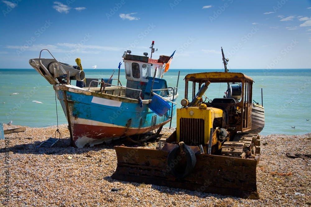 Fishing boat and a bulldozer, Hastings, East Sussex, UK.