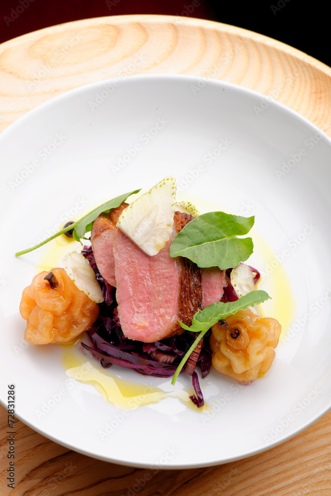 Roast duck, red cabbage and dry fruits in fine dining restaurant Roast duck, red cabbage and dry fruits in fine dining restaurant