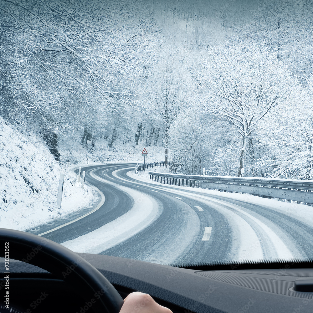 Obraz premium Winter Driving - Curvy Road Leading Through a Mountain Landscape
