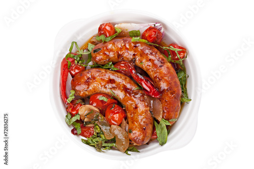 Sausages with stewed vegetables in bowl