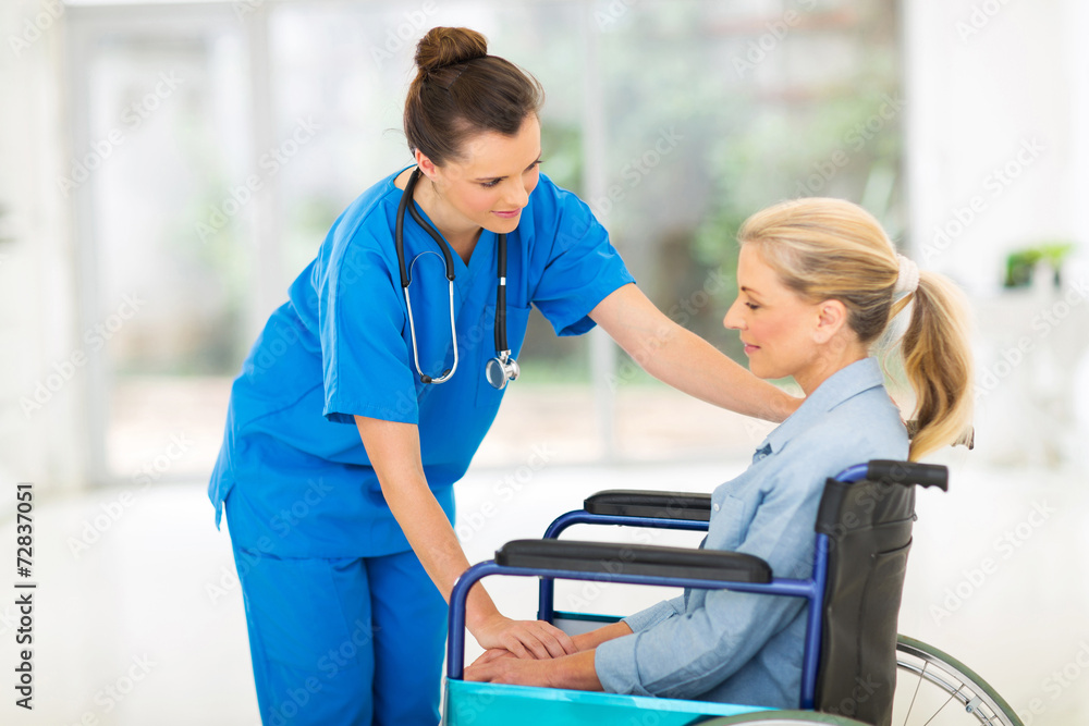 young female doctor comforting disabled senior patient young female doctor comforting disabled senior patient