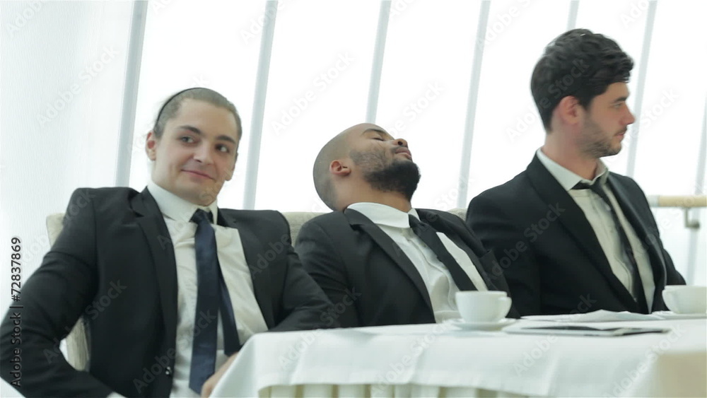 Young successful people stretch themselves at the table Young successful people stretch themselves at the table