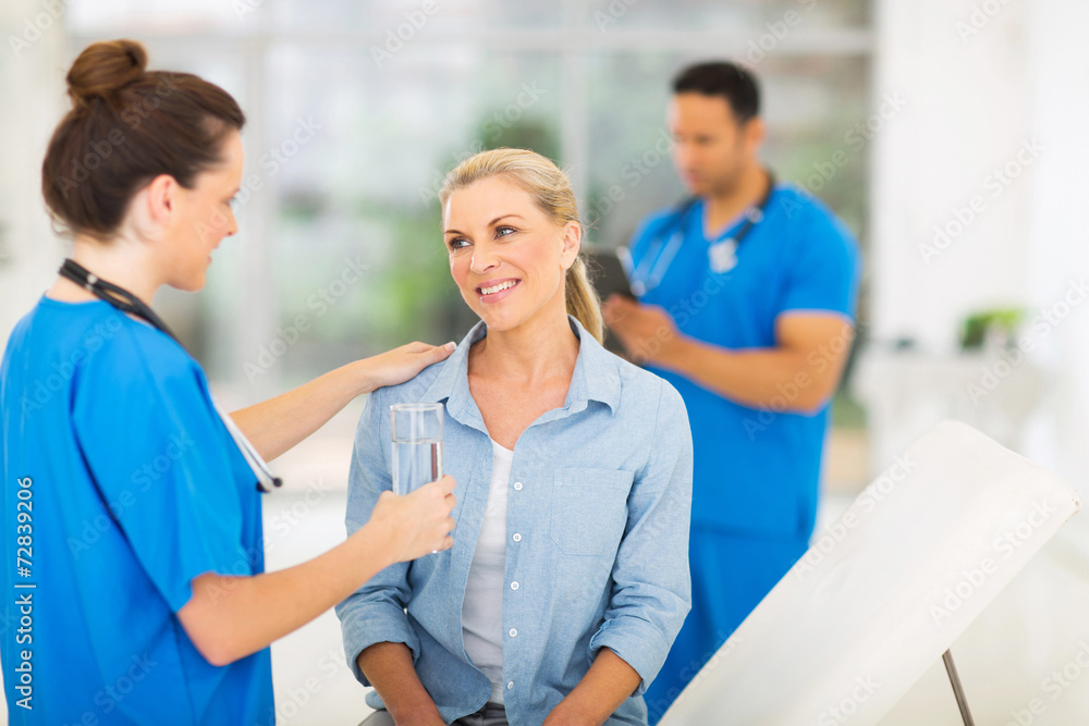 Fototapeta premium nurse giving patient glass of water