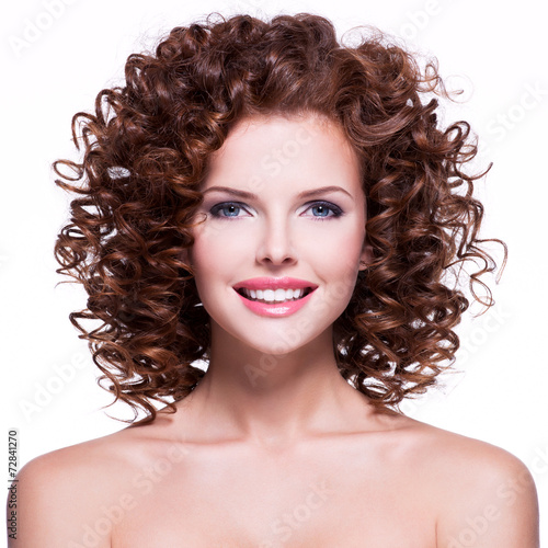 Beautiful smiling woman with brunette curly hair.