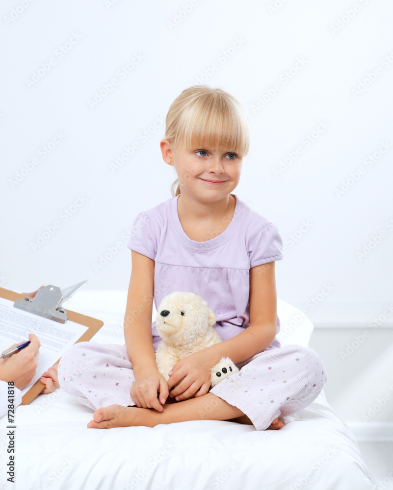 Female doctor examining child with stethoscope at surgery Female doctor examining child with stethoscope at surgery