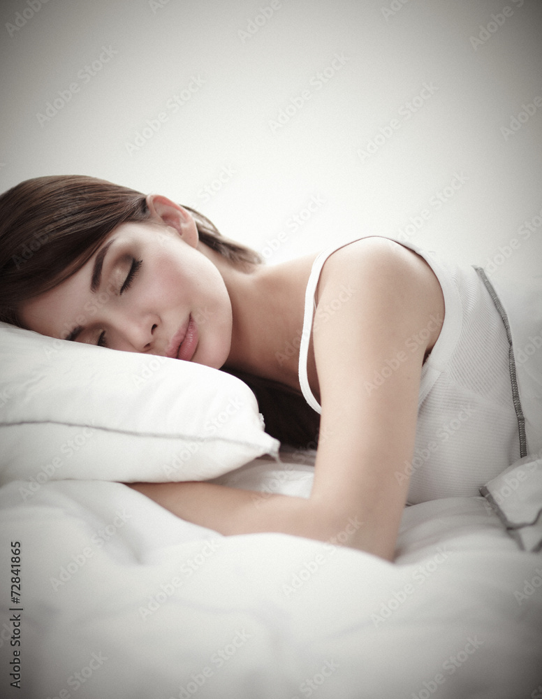 Beautiful girl sleeps in the bedroom, lying on bed Beautiful girl sleeps in the bedroom, lying on bed
