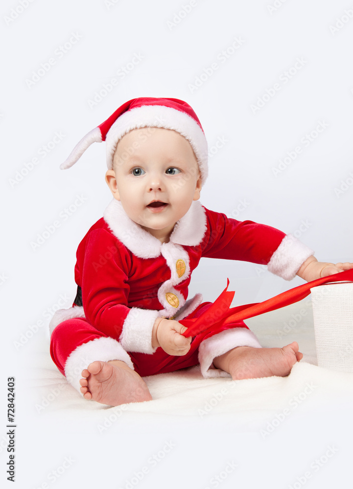 small child dressed as Santa Claus small child dressed as Santa Claus