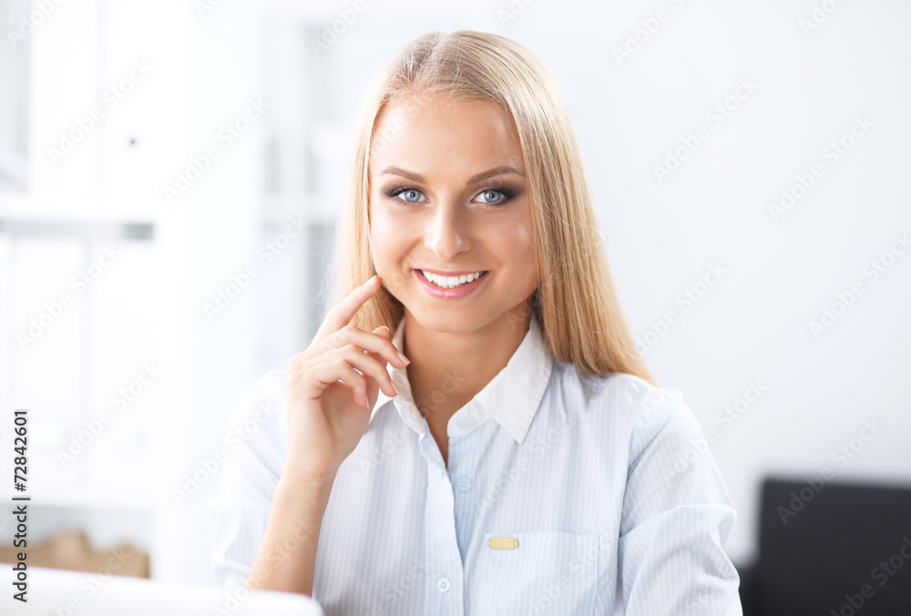Attractive businesswoman sitting in the office Attractive businesswoman sitting in the office