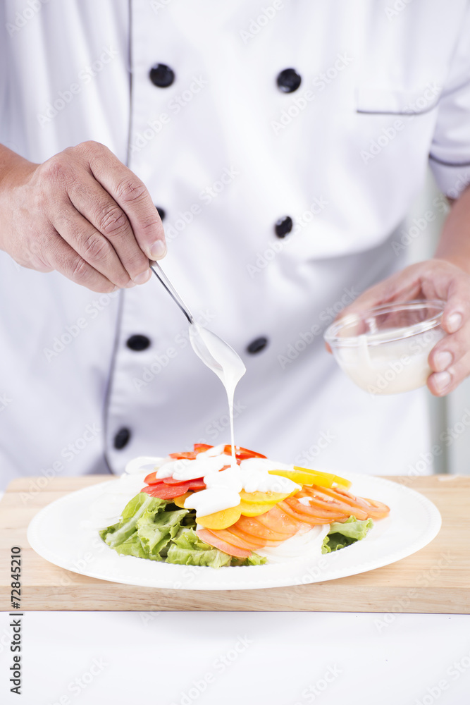 Chief putting salad dressing Chief putting salad dressing
