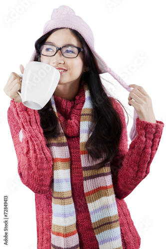 Cute girl enjoy hot drink in studio