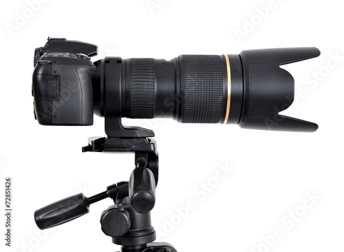 Fotografi DSLR camera with zoom lense on a tripod isolated