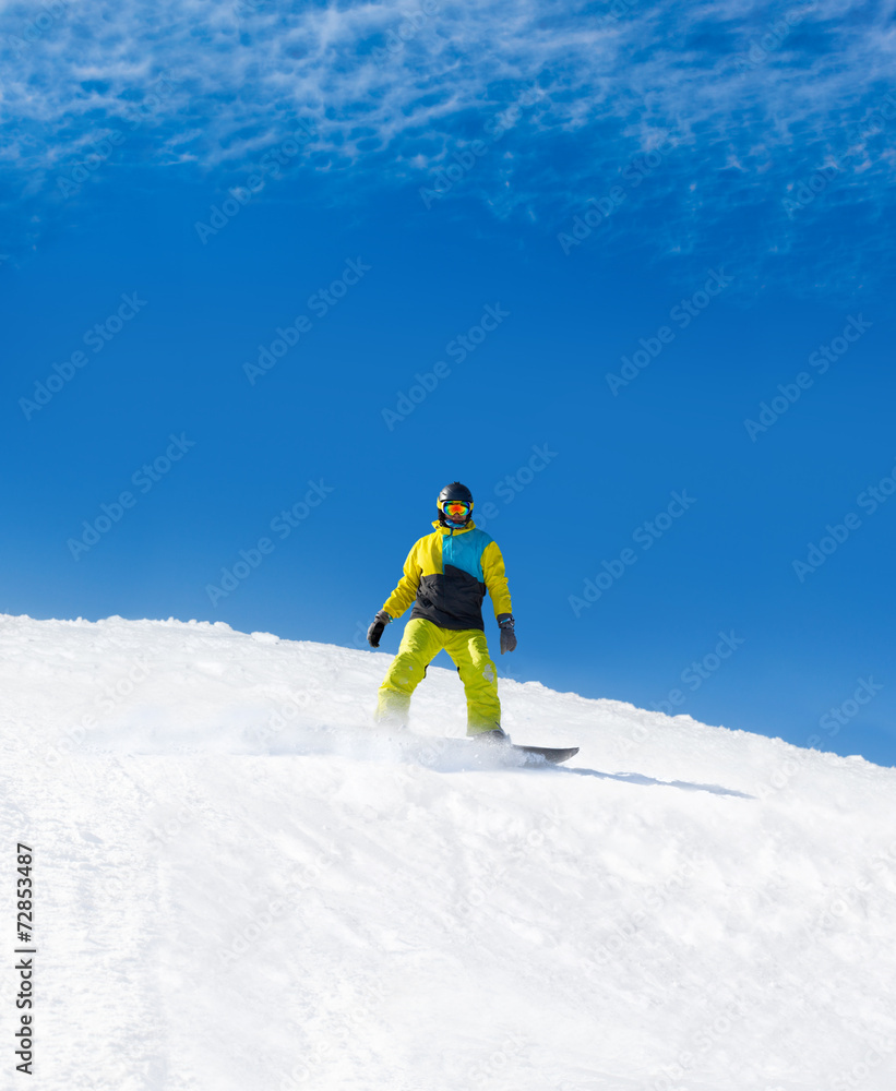 Snowboarder sliding down hill, snow snowboarding
