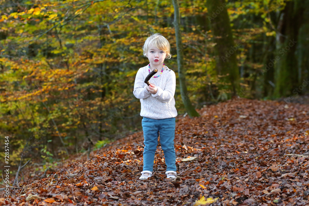 Little girl playing in the forest Little girl playing in the forest