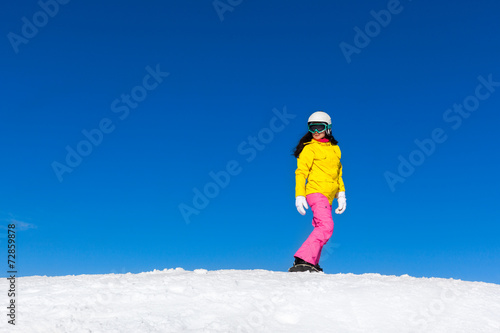 Snowboarder sliding woman down hill, snow mountains