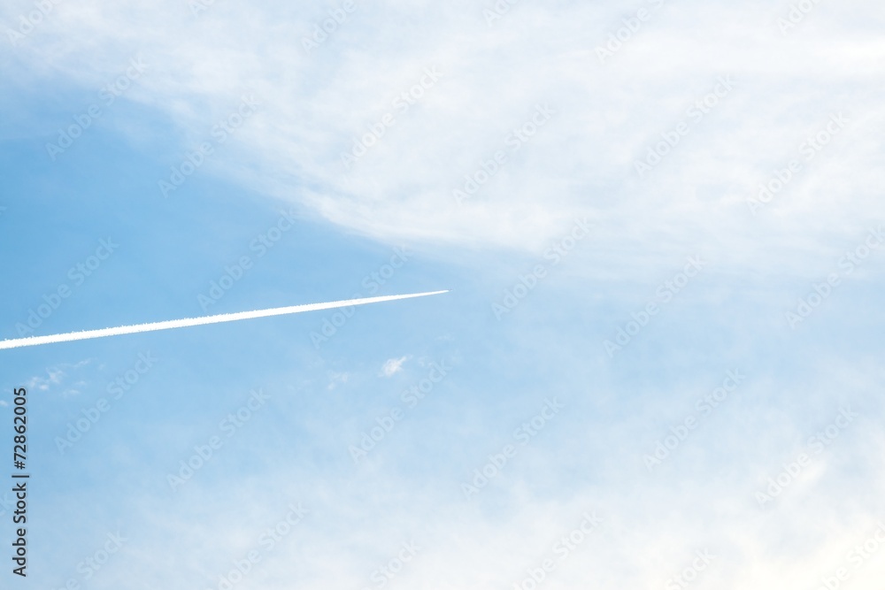 Airplane moving across blue sky Airplane moving across blue sky