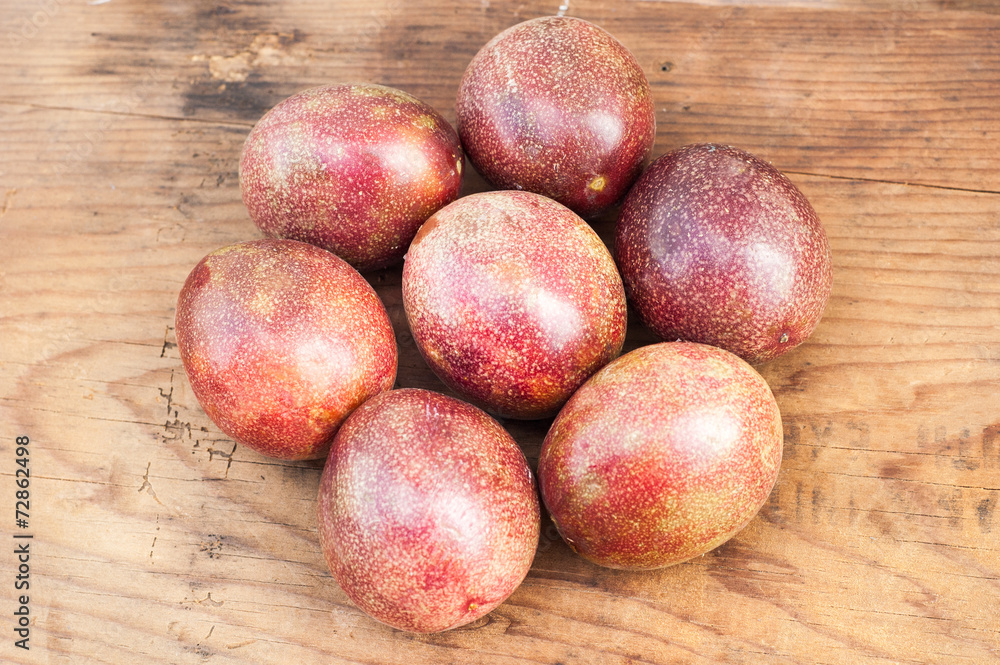 Ripe passion fruits on a wooden background Ripe passion fruits on a wooden background