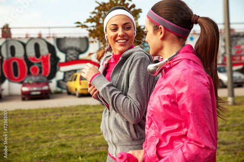 Two attractive female jogging together on beautiful morning. photo