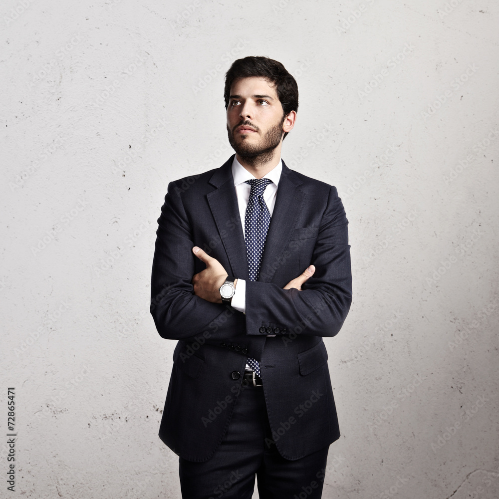 Portrait of a businessman on concrete wall background Portrait of a businessman on concrete wall background