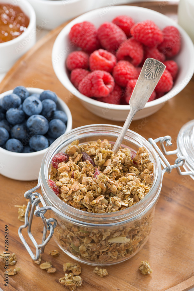glass jar with homemade granola and berries, top view glass jar with homemade granola and berries, top view