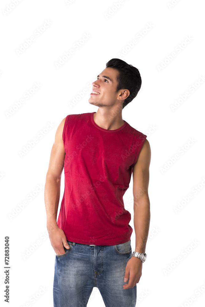 Happy smiling young man in red sleeveless shirt looking up Happy smiling young man in red sleeveless shirt looking up